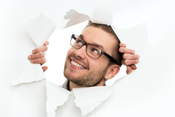 Wall Mural - man looking through hole in paper