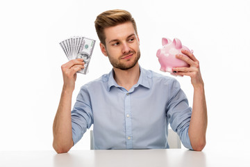 Wall Mural - man putting money in piggy bank
