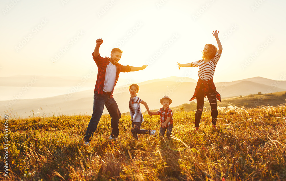 Happy family: mother, father, children son and daughter on sunset - obrazy, fototapety, plakaty 
