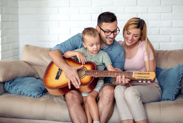 Poster - Happy family play guitar at home