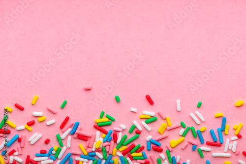 greeting background of colorful sprinkles over pink, festive invitation for V...