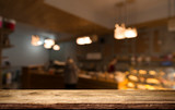 Fototapeta  - blurred background of bar and dark brown desk space of retro wood