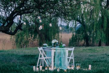 romantic breakfast at the well-served table outdoors in the beautiful garden