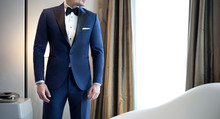 Man Model In Expensive Custom Tailored Blue Tuxedo, Suit Standing And Posing Indoors