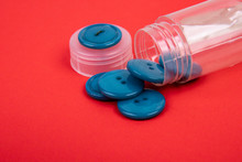 Blue Buttons From A Button Box On A Red Background