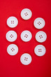 © Mitch Shark - white buttons in a pattern on red background
