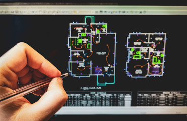 cad software drawing on the computer screen with hand holding pen