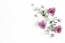 Flowers Composition. Pattern Made Of Eucalyptus Branches And Rose Flowers On White Background. Flat Lay, Top View, Copy Space