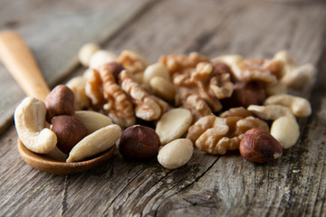 Wall Mural - Nuts mix over wooden background. Energy super food. Proteine food. dieting, healthy food. Isolated nuts - almonds, hazelnuts,cashew, brazil nuts.