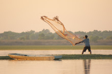 NAKHON PHANOM, THAILAND - Nov 4, 2018 : Fisherman Casting A Net Into The Lake