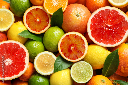 Cuadros en Lienzo Different citrus fruits as background, top view
