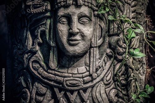 Fotomural Beautiful rocky monument with a carved image of a human face in the jungle