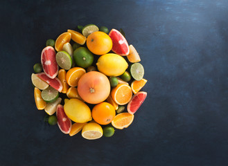 Wall Mural - Assorted citrus fruits on blue rustic background.