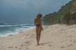 © South House Studio - excellent photo of nice models butt, girl in black bikini jogging along beach