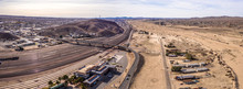 Aerial View Of Barstow Community A Residential City Of Homes And Commercial Property Community Mojave Desert California USA At Sunset. Railway Station And Museum