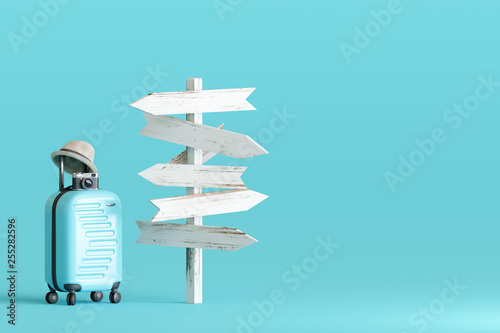 Blue suitcase and hat, camera with signpost on pastel blue background Poster Mural XXL