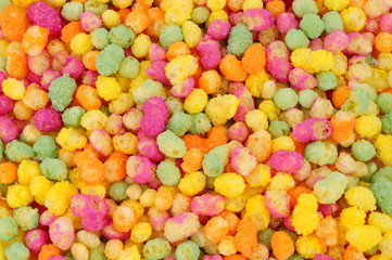Rainbow coloured puffed maize and rice confectionery background