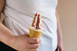 overweight woman eating ice-cream. unhealthy fattening food,high-calorie snack. fattie with sundae in waffle cone