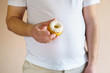 fattening food, high-calorie snack. weight loss, dietary, balanced nutrition. overweight man eating unhealthy sweet donut