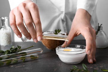 Beautician preparing natural cosmetics, closeup