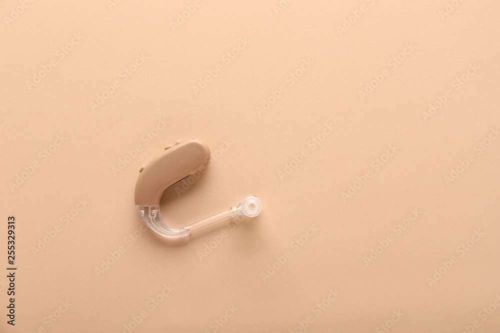 Hearing aid on color background