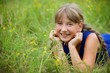 © Fotoproff - School-age girl in a blue dress with two long braids.