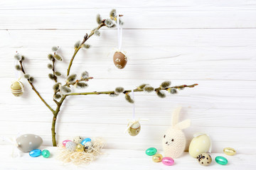 Easter eggs and rabbit on catkins background