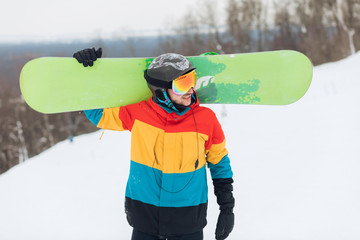 attractive man in special sportswear is in the ski area, close up photo.