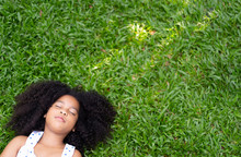 Top View Of Child Or Little Girl Relax Or Sleeping Or Lying On Grass On The Grass In Summer,rest One's Eyes Or During The Lunch Break With Copy Space For Text Your. Freedom ,peace Lifestyle Concept