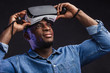 © alfa27 - Handsome excited ethnic man, testing oculus VR for first time, feeling adoration and amazement. A virtual simulator 360 degree reality impressed him a lot