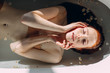 © alfa27 - Young pretty redhead woman with coopery hair taking bath. Sensual sexy female model relaxing in a bathtub, close up. Youth and Skin and Body Care Concept.