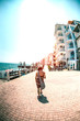 © zhukovvvlad - A woman walks along the waterfront street.