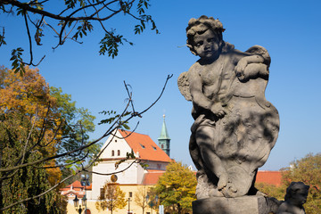 Wall Mural - PRAGUE, CZECH REPUBLIC - OCTOBER 14, 2018: The baroque angel before facade of Loreto church  - designed by Kilian Ignac (1772).