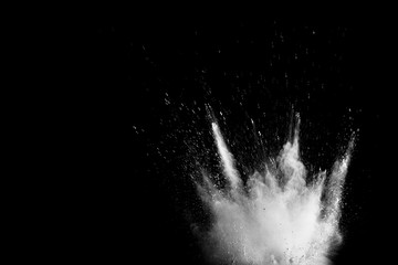 Wall Mural - White powder explosion isolated on black background. White dust particles splash.Color Holi Festival.