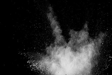 Wall Mural - Bizarre forms of white powder explosion cloud against black background.White dust particles splash.