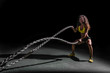 woman training crossfit with ropes