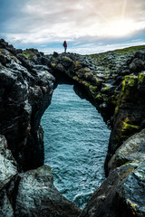 Wall Mural - Rock bridge landscape in Arnarstapi, Iceland. Arnarstapi was an important trading post of West Iceland in the past.