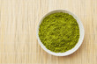 Top view of white plate with green tea powder or matcha used as Asian or Japanese