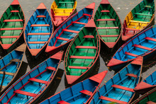 Traditional Colored Wooden Rowing Boats In Pokhara, Nepal An Early Morning Before They Go Out Onto The Lake. Classic View In Pokhara. 