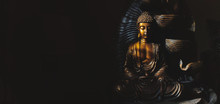 Golden Gautama Buddha Statue With A Black Background.