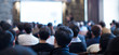 Audience Listens to Lecturer at a Conference Meeting Seminar Training. Group of People Hear Presenter Give Speech . Corporate Manager Speaker Gives Business Technology and Economic Forecast.