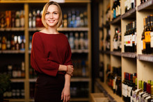 Image Of Happy Blonde Woman In Store With Wine
