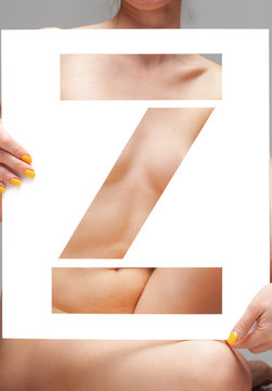 nude girl holding stencil letter z