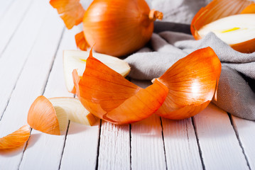 Poster - onion cutting on white wooden background