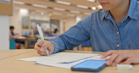 Wall Mural - Woman write on the paper at library