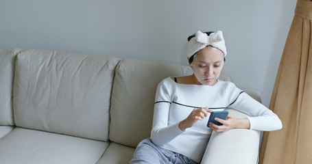 Poster - Woman use of paper mask with cellphone