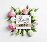 Beautiful Eustoma flowers and card on light background