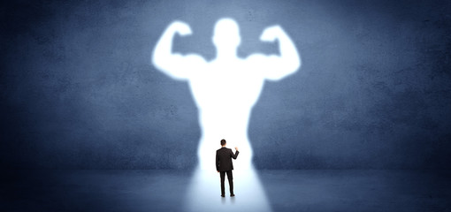 Wall Mural - Businessman standing and dreaming about a strong superhero