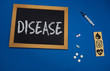 © taiga - wooden tablet on blue medical table with the word DISEASE