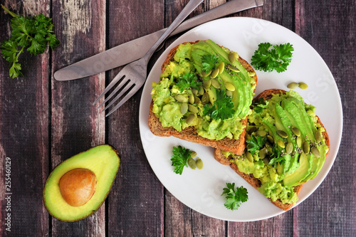 Cuadros en Lienzo Avocado toasts with pumpkin and chia seeds on whole grain bread